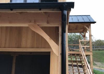 Black gutters and downspouts lined up looking beautiful.