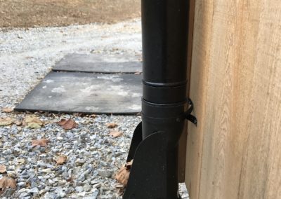 Leaf chute tied into an underground pipe. Leafs sticking out the opening.