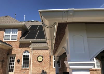 White gutters on a pool house. Beautiful corner, compared to the view of the gutters on the main house, they are light years apart.
