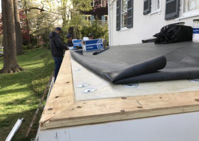 Roof underlay where you attach the gutter hangers. Roof membrane rolled up exposing the plywood and sheet rock.