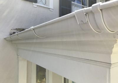 White gutter with roof hangers.