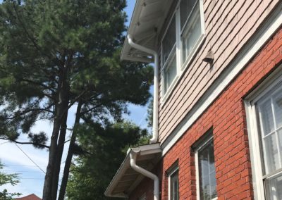 Very nice symmetry between the second floor and the first floor installation of the white gutters and downspouts. The line up perfectly.