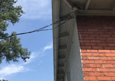 White corner with exposed rafter tails .