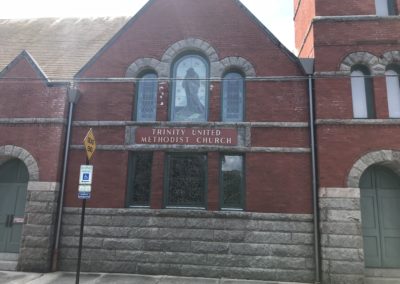 Church side with red brick and grey stone. Two leader heads into downspouts in anthracite metallic.