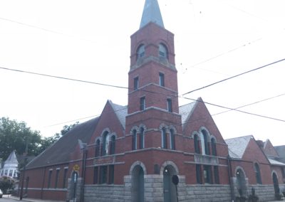 Red brick church with grey stone. Anthracite metallic gutters looks very nice in combination.