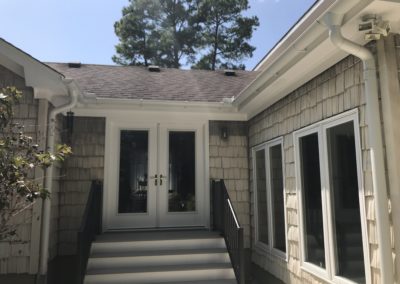French doors. White gutters with two inside corners.