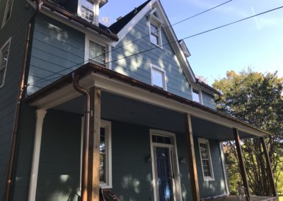 Copper metallic half round gutters. Beautiful against the green siding and the white trim.