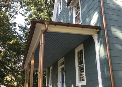 Beautiful copper metallic gutter systems on porch and second floor. Very smooth looking and classy.